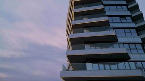 Modern residential building with glass balconies and LED lighting at sunset. Urban architecture and city living concept with soft sky reflections and evening ambiance - Powered by Shutterstock - Get 15% off with code: PIKWIZARD15
