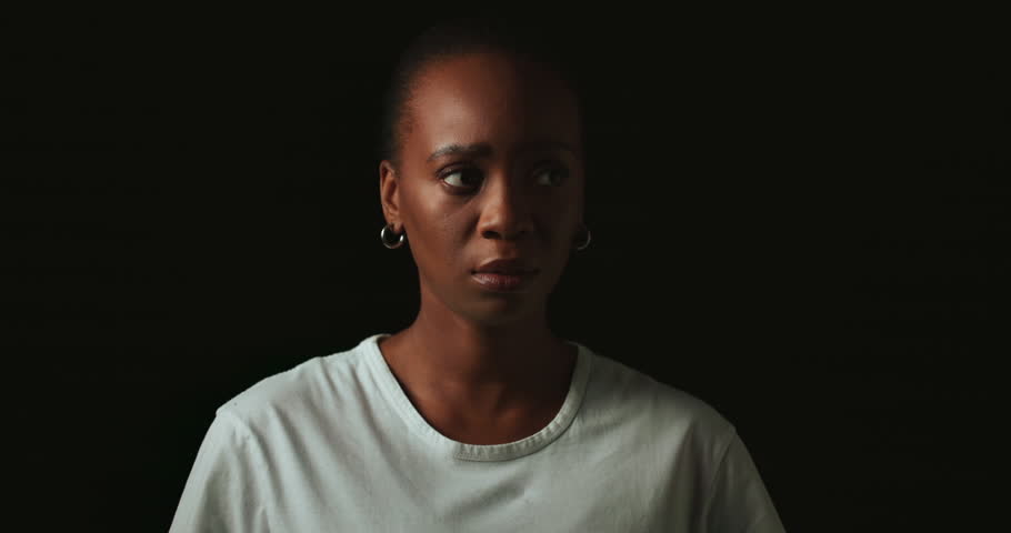 Scared, worry and black woman on dark background with fear, nervous and confused face expression. Stress, anxiety and isolated female person with phobia, emotions and crisis reaction in studio