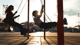 Happy female baby kid and adolescent swinging on swing at wooden sunny playground public park side view. Overjoyed girl children relaxing outdoor flying freedom leisure recreation activity bright sun - Powered by Shutterstock - Get 15% off with code: PIKWIZARD15