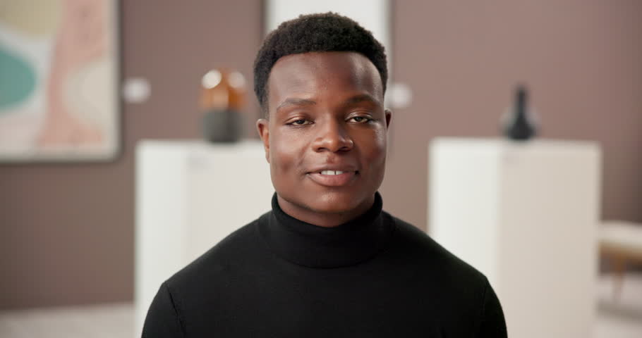 Art gallery, curator and face of happy black man with confidence, culture and creative business. Exhibition critic, sales agent or artist at presentation, auction or painting showroom with smile
