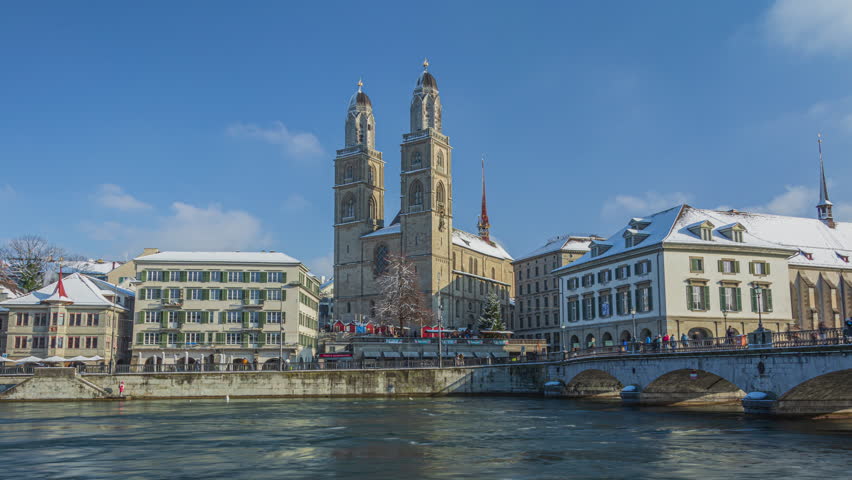 Time lapse, European town covered with snow. Grossmunster in winter. Zurich old town along the Limmat river with the Grossmunster cathedral. Zurich, Switzerland.