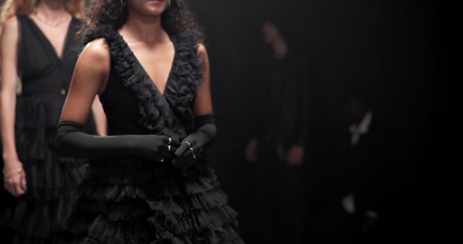 Runway, walking and models at fashion show with designer collection for luxury trendy outfit. Fabric, body and people at couture event with black clothes for formal, elegant or fancy style at catwalk