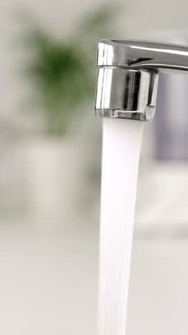 Water running from Faucet tap. Nobody. Vertical footage