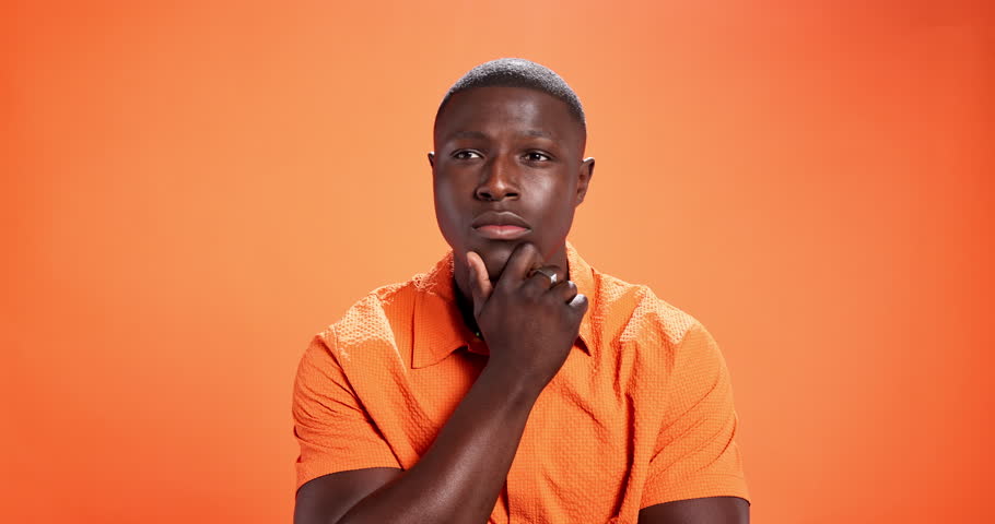 Fashion, face or black man thinking of solution in studio with insight, creative idea or aha moment. Mockup, person and happy with style inspiration, problem solving and eureka on orange background