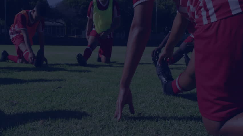 Male soccer team kneeling stretching while clear finance chart overlay fading showing market rally. Athletes, teamwork, strategy, motivation, training, outdoor, energetic