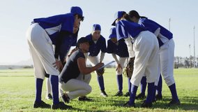 Baseball coach kneeling on field pointing and noting plan as players huddling and emojis cascading. Coaching, teammeeting, strategy, sportsmanship, athleticism, outdoor, teamwork - Powered by Shutterstock - Get 15% off with code: PIKWIZARD15