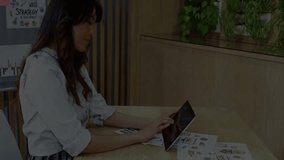 Woman tapping tablet reviewing charts as green hologram growing and dissolving during tech demo. Futuristic, innovation, technology, digital, interface, creative, modern - Powered by Shutterstock - Get 15% off with code: PIKWIZARD15