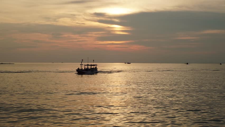 Sunset timelapse over the tranquil harbor of West Port, Karimunjawa. Calm sea, glowing sky, and silhouettes create a serene tropical evening moment.