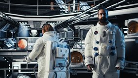 Astronaut waves hand, communicating with command center during videocall to share recent orbit discoveries. Cosmonaut salutes Earth team, provides scientific findings from spacecraft, camera A - Powered by Shutterstock - Get 15% off with code: PIKWIZARD15