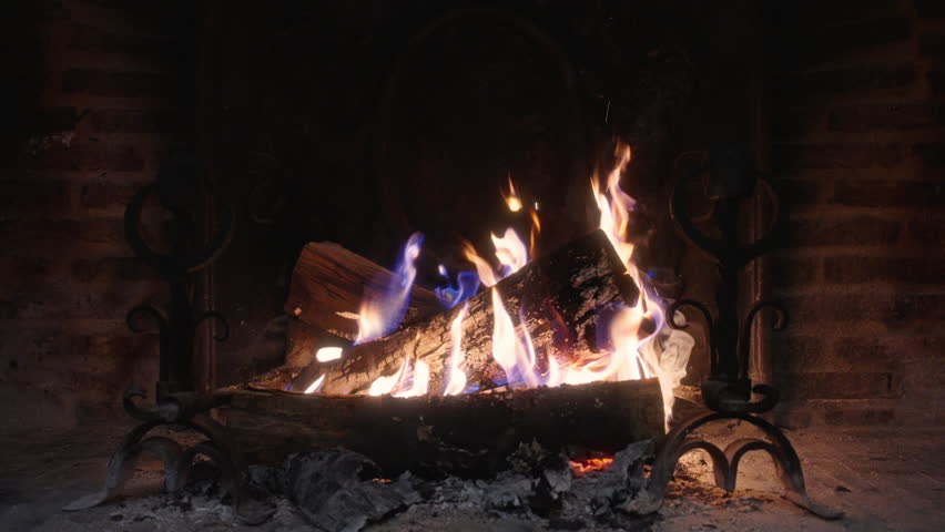 Immerse yourself in the enchanting beauty of a crackling fire that dances within a cozy fireplace, lovingly showcased in slow motion, bringing forth warmth and tranquility to elevate any ambiance