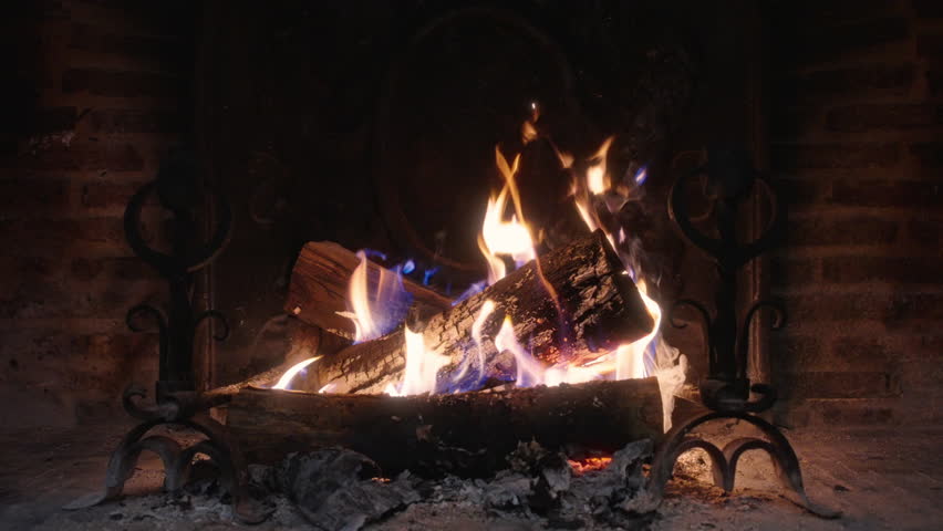 Immerse yourself in the enchanting beauty of a crackling fire that dances within a cozy fireplace, lovingly showcased in slow motion, bringing forth warmth and tranquility to elevate any ambiance