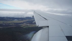 Enjoy the captivating scenes viewed from an airplane window as it gracefully descends through soft clouds, revealing vibrant city lights below - Powered by Shutterstock - Get 15% off with code: PIKWIZARD15