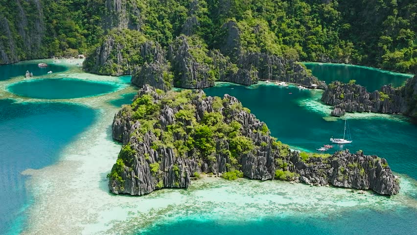 Twin Lagoon with turquoise water. Boats running around the Lagoons. Coron, Palawan. Philippines.