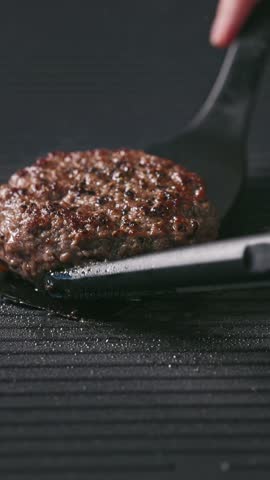 cook turn around fresh ground beef burger meat patty cooking on hot grill, food closeup