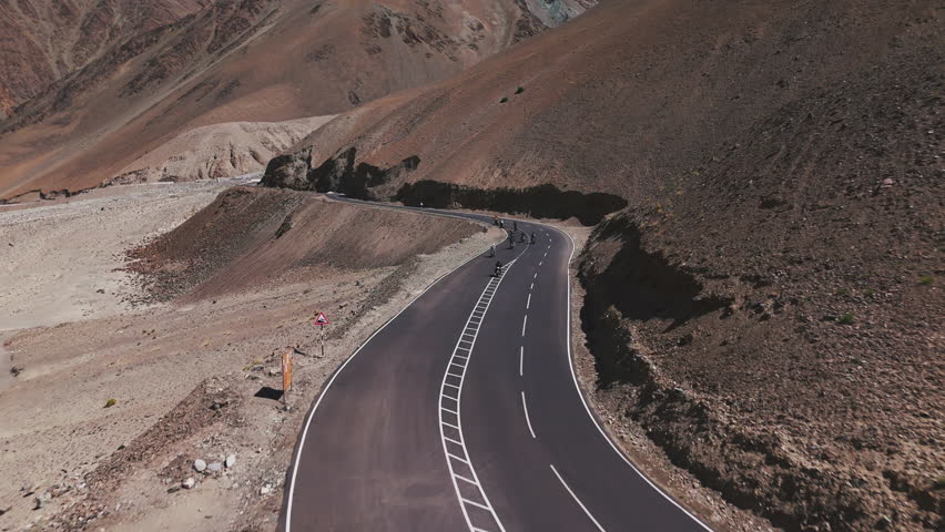 Motorcyclists Riding on Mountain Road in Tibet Drone View