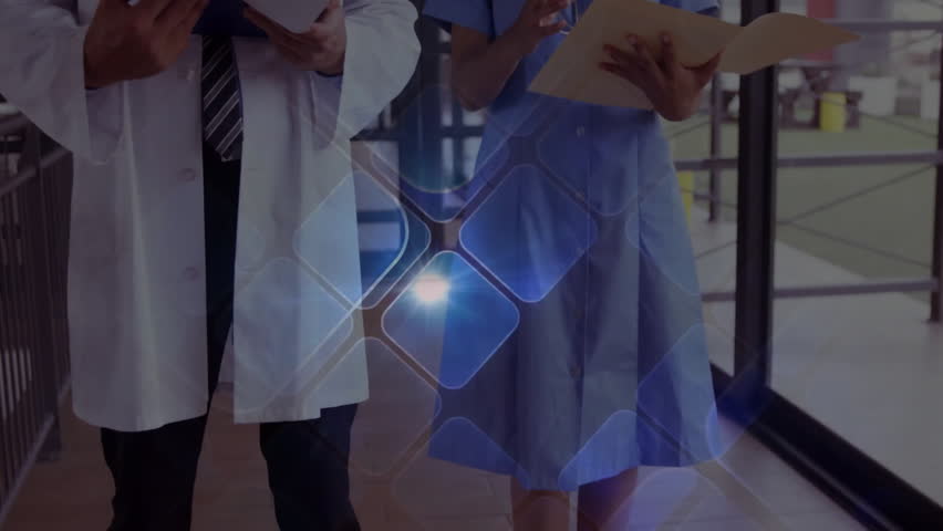 Doctor and nurse walking hall flipping files activating hexagonal grid guiding medical analysis. Healthcare, professionalism, innovation, teamwork, technology, modern, communication