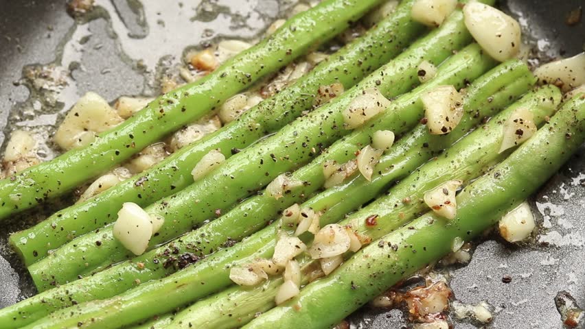 Cooking Snap Bean With Garlic And Black Pepper In Frying Pan. Top View Shot