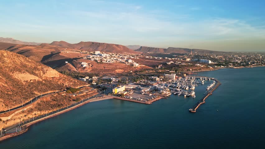 Peaceful coastal marina with desert hills, La Paz Malecon Calavera, golden sunset light