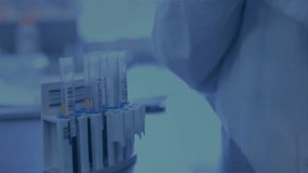 Gloved hand entering from right grabbing test tube, rotating inspecting sediment under mesh overlay. Scientist, experimentation, microscopy, precision, innovation, scientific, research - Powered by Shutterstock - Get 15% off with code: PIKWIZARD15