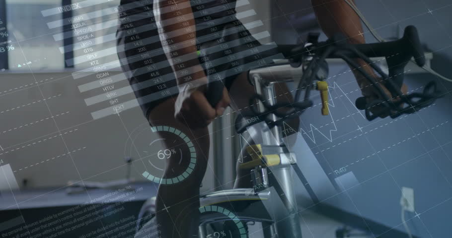 Male athlete gripping handlebars and pedaling in sports lab for testing data charts updating stats. Fitness, endurance, analytics, performance, biomechanics, training, health