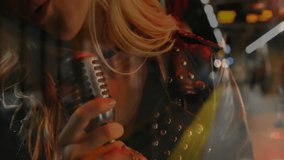 Female singer gripping mic singing in music rehearsal shifting lights behind guitarist strumming. Performance, music, vocals, stage, entertainment, creativity, artistic - Powered by Shutterstock - Get 15% off with code: PIKWIZARD15