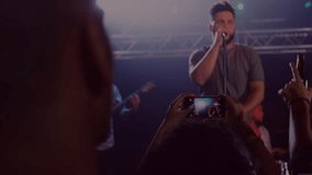 Singer entering concert stage singing and guitarist strumming particles floating engaging crowd. Live music, performance, dynamic, entertainment, concert, audience, vibrant - Powered by Shutterstock - Get 15% off with code: PIKWIZARD15