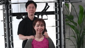 Asian male chiropractor and female patient making OK hand sign - Powered by Shutterstock - Get 15% off with code: PIKWIZARD15