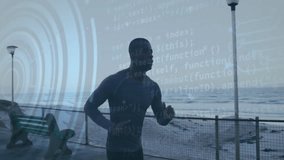 Mid-adult male runner starting jog along seaside path at dawn activating overlay tracking fitness. Athletic, technology, performance, wellness, outdoor, energetic, fitness - Powered by Shutterstock - Get 15% off with code: PIKWIZARD15