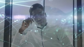 Man adjusting eyeglasses and picking up pen after network graphics appearing for data analysis. Technology, innovation, data visualization, futurism, corporate, professional, digital interface - Powered by Shutterstock - Get 15% off with code: PIKWIZARD15