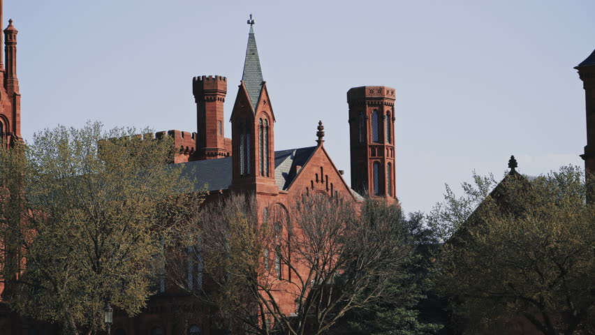 Red Brick Smithsonian Castle with Multiple Towers in Spring Light