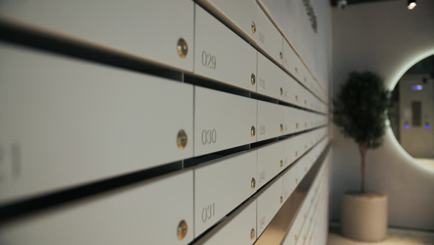 Row of numbered mailboxes in modern apartment building