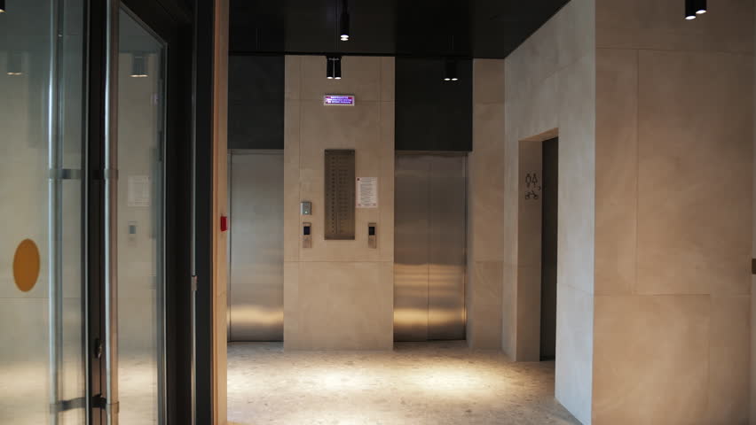 Modern elevator lobby with beige walls