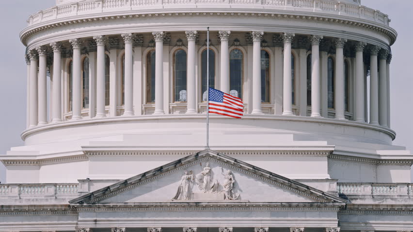 US Capitol Dome with American Flag low angle view 