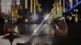 Drummer raising stick and striking cymbal repeatedly while city lights pulsing with musical rhythm. Music, performance, nightlife, urban, rhythm, energy, stage - Powered by Shutterstock - Get 15% off with code: PIKWIZARD15