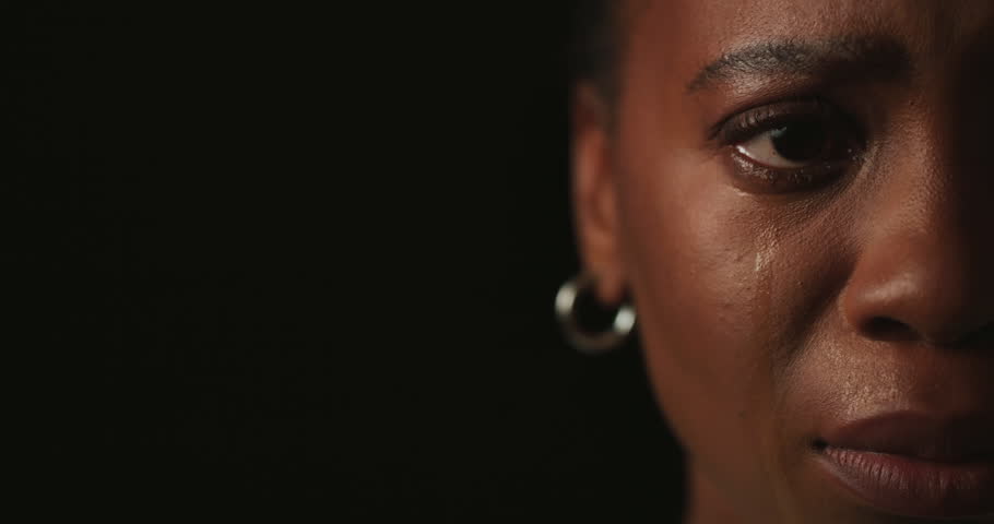 Face, half and black woman in studio, crying and mental health on dark background. African person, mockup space and model with tears, depression and sad with anxiety, portrait and abuse with pain