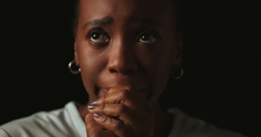 Stress, worry and tears of black woman on dark background with fear, nervous and face with expression. Scared, anxiety and isolated female person with phobia, emotions and crisis reaction in studio