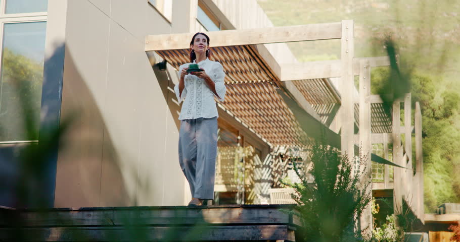 Morning, coffee and woman on patio in home for relaxing, calm and reflection in backyard. Thinking, thoughtful and person with drink, warm beverage and caffeine outdoor for peace, wellness and rest