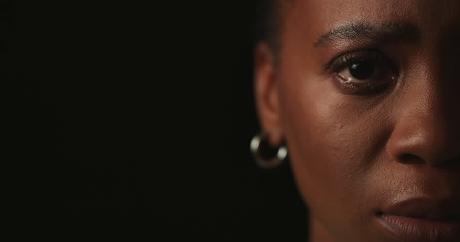 Face, half or black woman in studio, tears or mental health on dark background. African person, portrait or closeup with depression, stress or sad with anxiety, cry or abuse with mockup space or pain