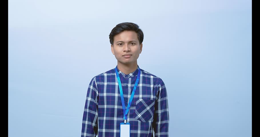 An Asian employee uses a strap and points at something above.