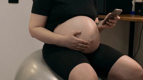 Pregnant woman swings on fit ball and using smartphone. Exercise and relax back on 9 months of Pregnancy. Taking care of the health of mom and baby during pregnancy concept - Powered by Shutterstock - Get 15% off with code: PIKWIZARD15