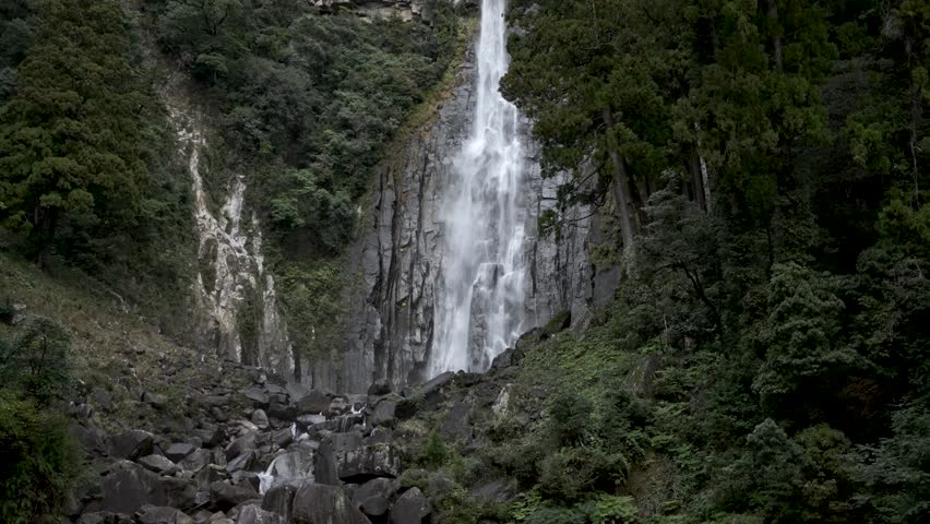 Beautiful Nachi Falls streaming down cliffs surrounded by verdant forest in Nachikatsuura, Japan.