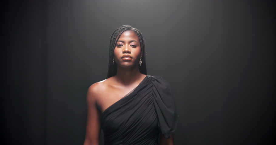 Studio, black woman and face with walking for runway, event and presentation of fashion with mockup. Female person, model and portrait with pride for clothing show, designer dress and dark background