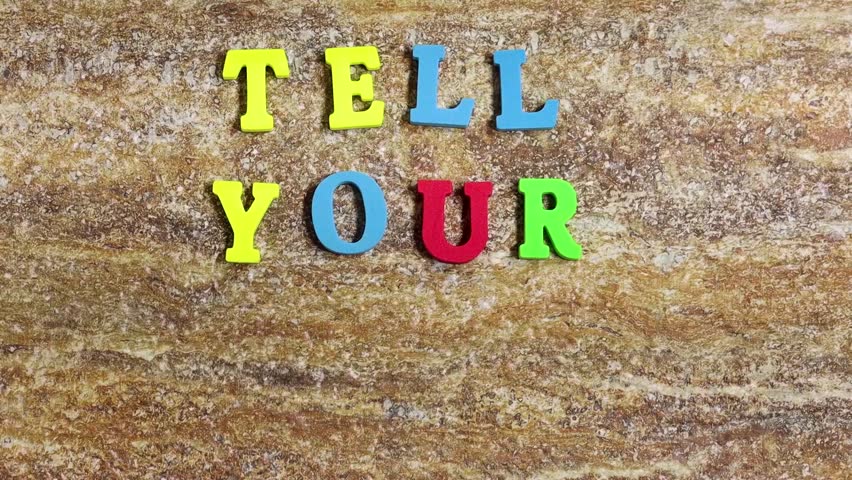 forming tell your story concept with colorful alphabets on grunge stone