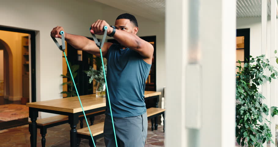 Man, exercise and resistance band for fitness for strength training, bicep workout and wellness. Male person, equipment and stretching for bodybuilding, muscle growth and morning routine at house