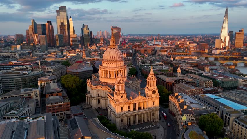 Panoramic aerial view of the London skyline with St. Pauls Cathedral, the city skyscrapers at River Thames during golden sunset time
