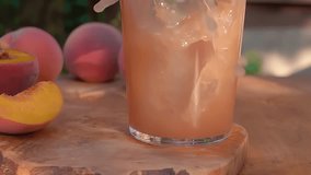 Peach juice is poured into a glass forming a beautiful wave. High quality 4k footage - Powered by Shutterstock - Get 15% off with code: PIKWIZARD15