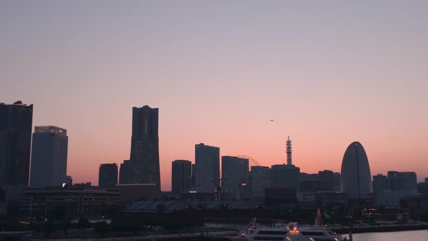 Yokohama, Japan - 05 June 2025 : 4K video of urban night view of Minato Mirai, Yokohama, Japan, taken during early summer sunset time