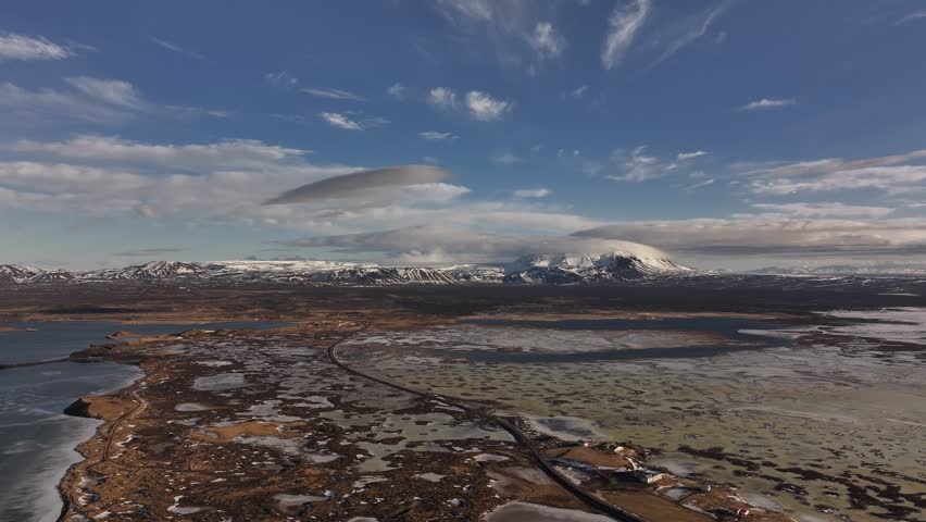 Stunning aerial panorama of Reykjahlíð and Lake Mývatn, Iceland, with volcanic terrain.