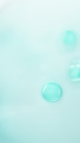 3d Vertical blue molecular serum bubbles floating in soft light, showcasing active ingredients. Perfect skincare element for luxury cosmetic, hydration, anti-aging, and beauty visuals.	