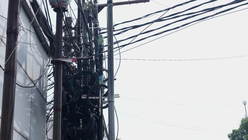 chaotic messy untidy dangerous electric cable high voltage terminal junction box power pole fire hazard tangled